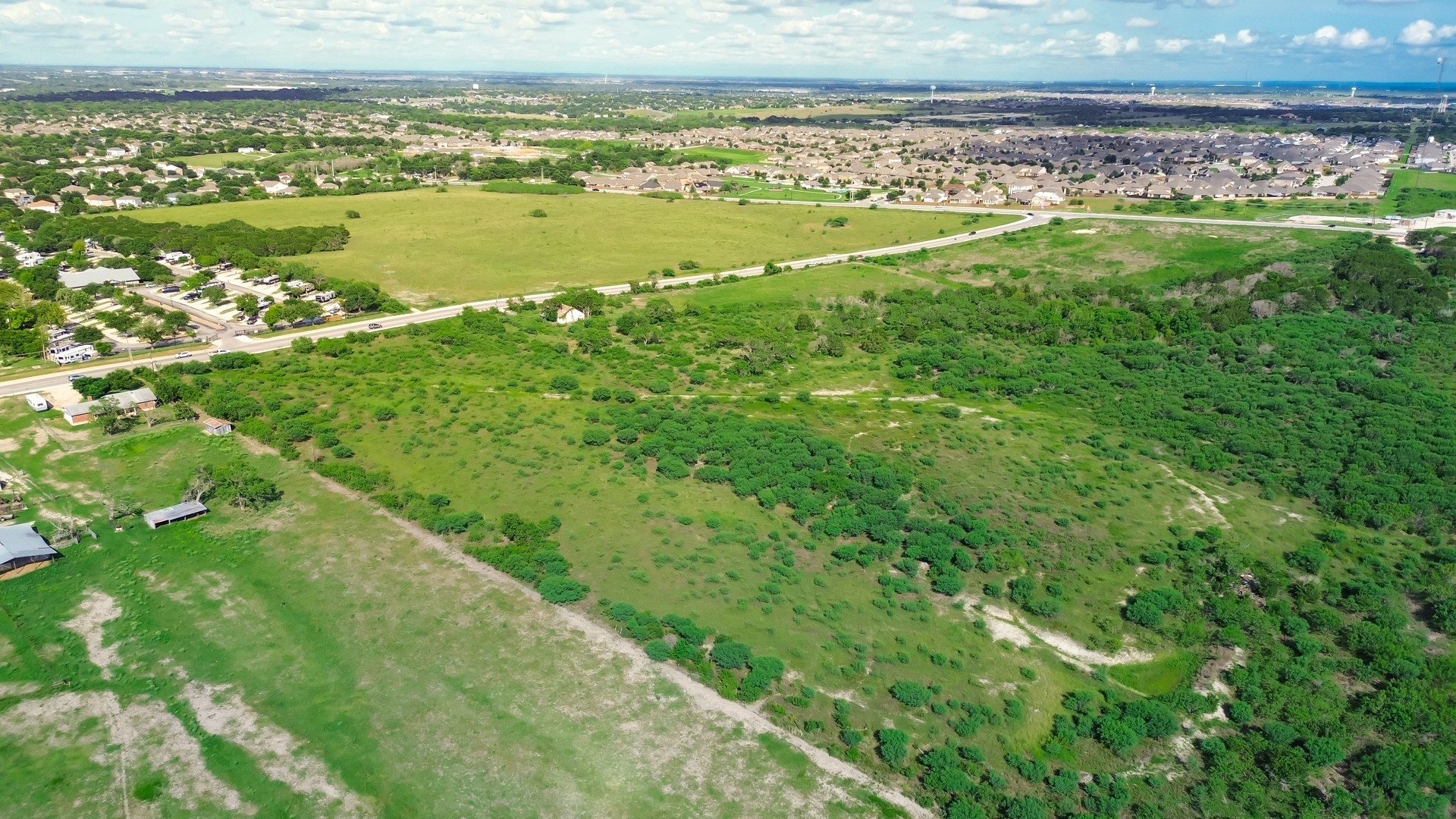 Large vacant land near new development residential neighborhood houses in New Braunfels, suburbs San Antonio, master planned community to grow along Rueckle Road and Morningside Drive, aerial